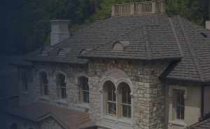 Beautiful stone house with architectural shingled roof